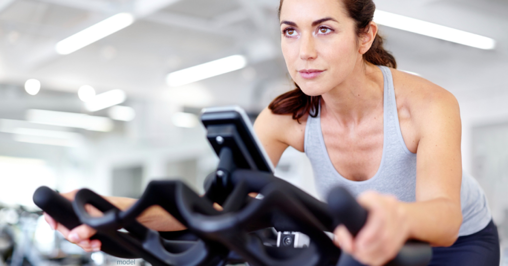 (model) woman on stationary bike